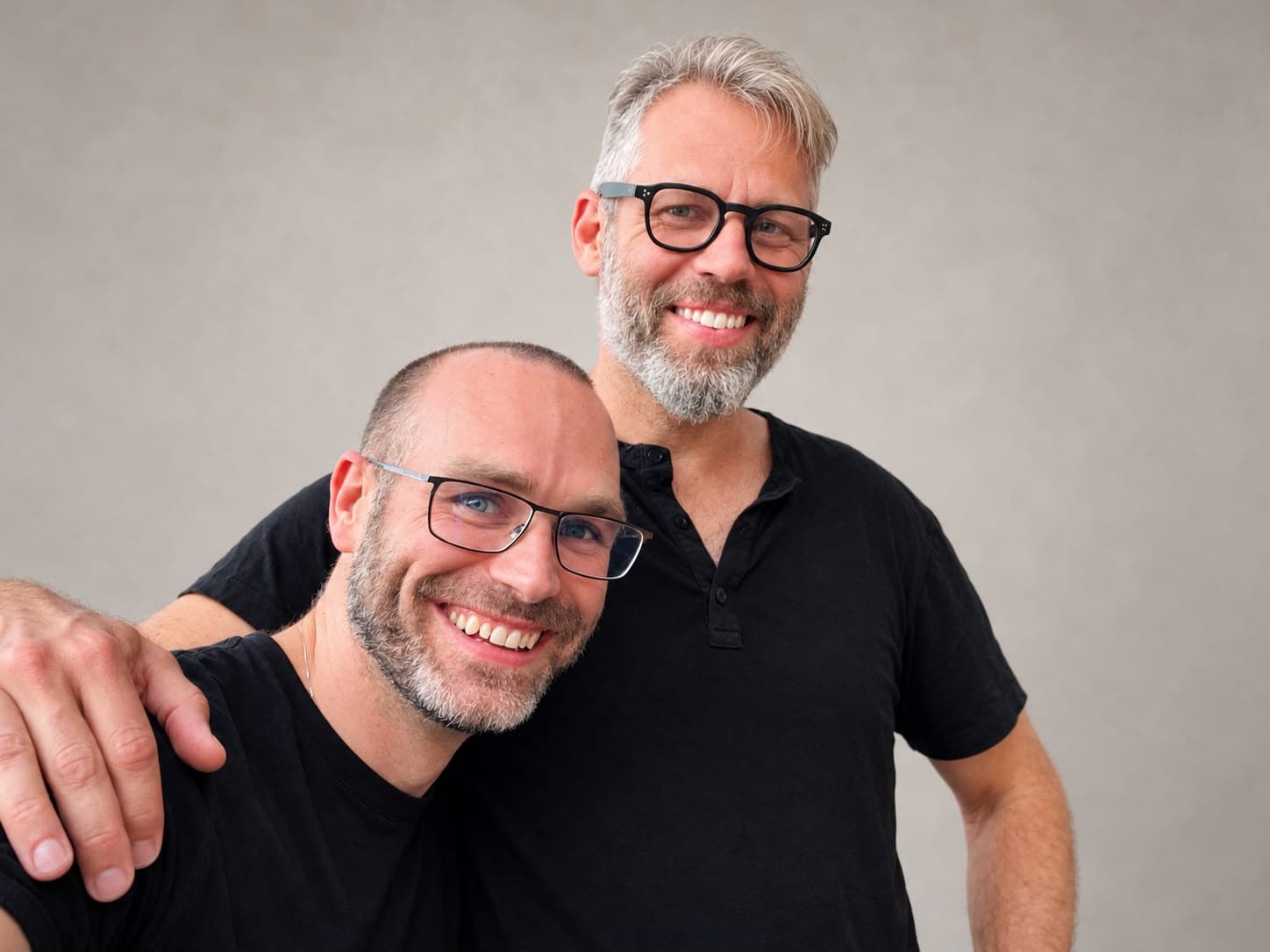 A patient and a clinician smiling together, the patient’s hand on the clinician’s shoulder.