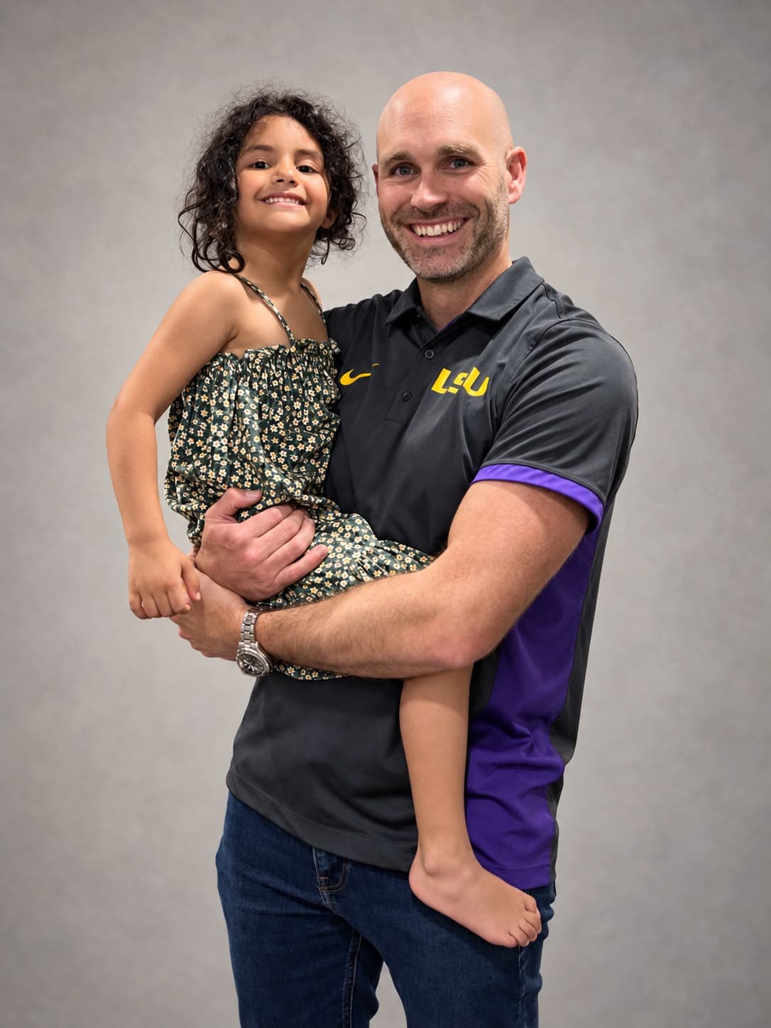 Dr. Daigle holding a child.