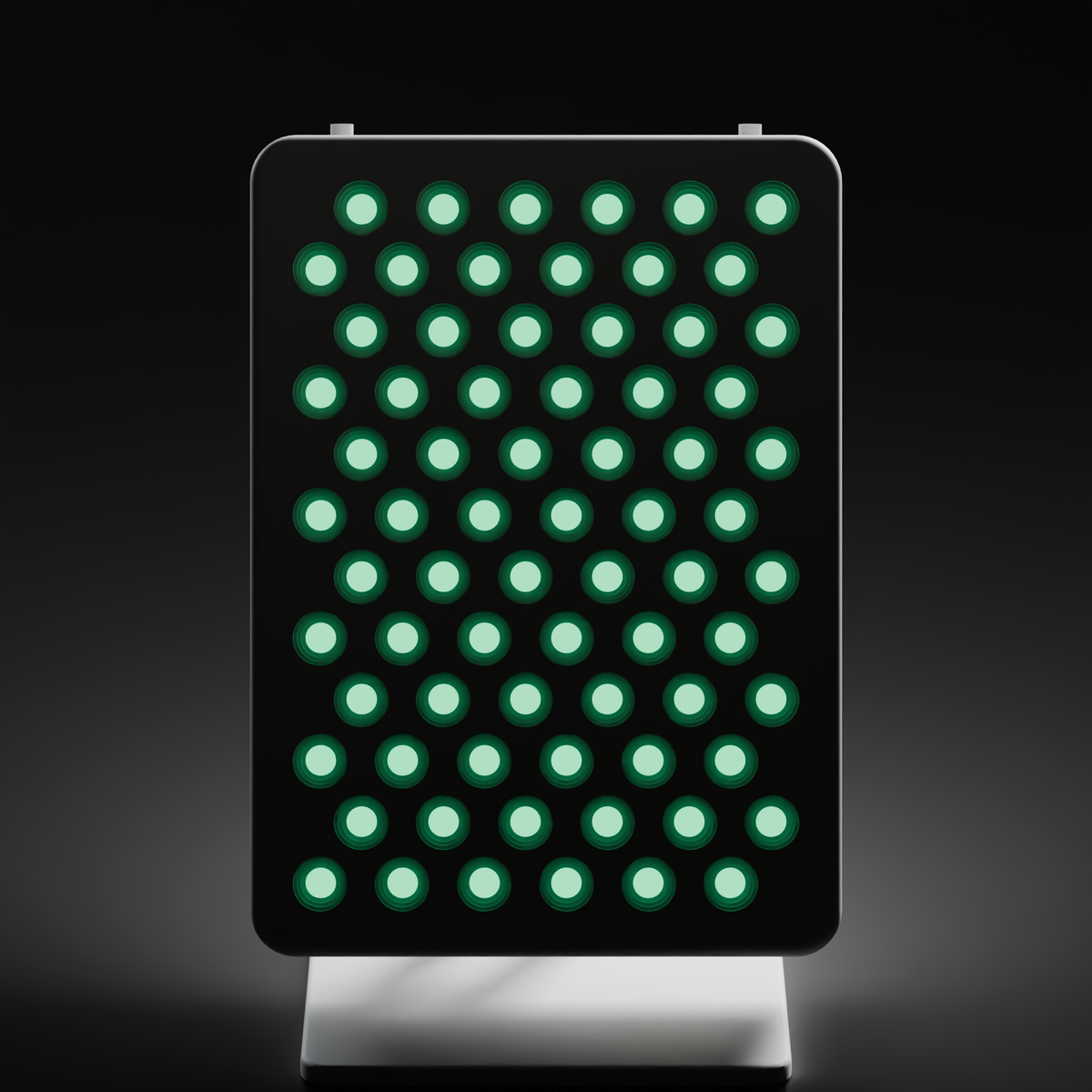 Front view of the DRKD Retreat 32 with all 72 green LEDs lit, arranged in 12 staggered rows of 6 across a white portrait-format face.